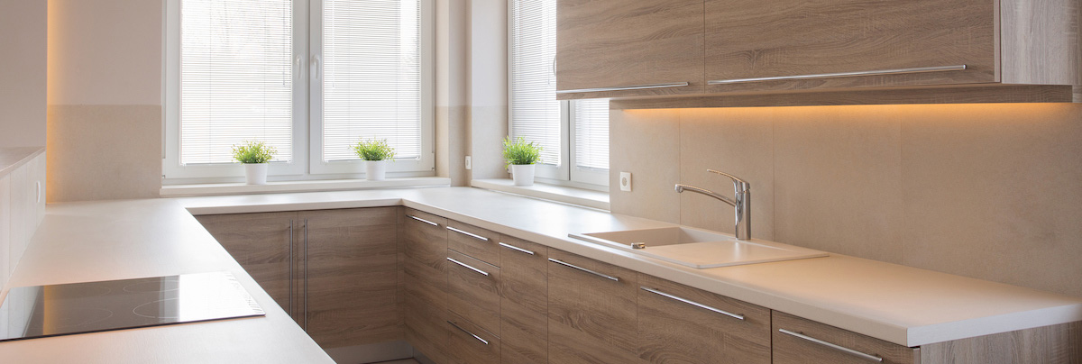 u shaped kitchen with wooden cabinets and induction hob