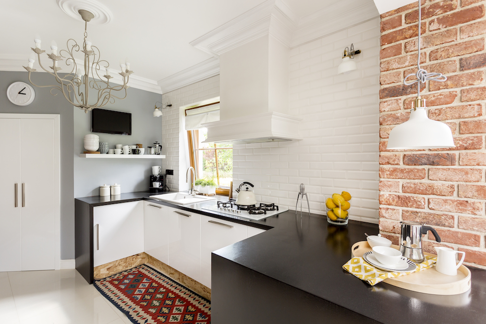 small kitchen renovation with a black bench 