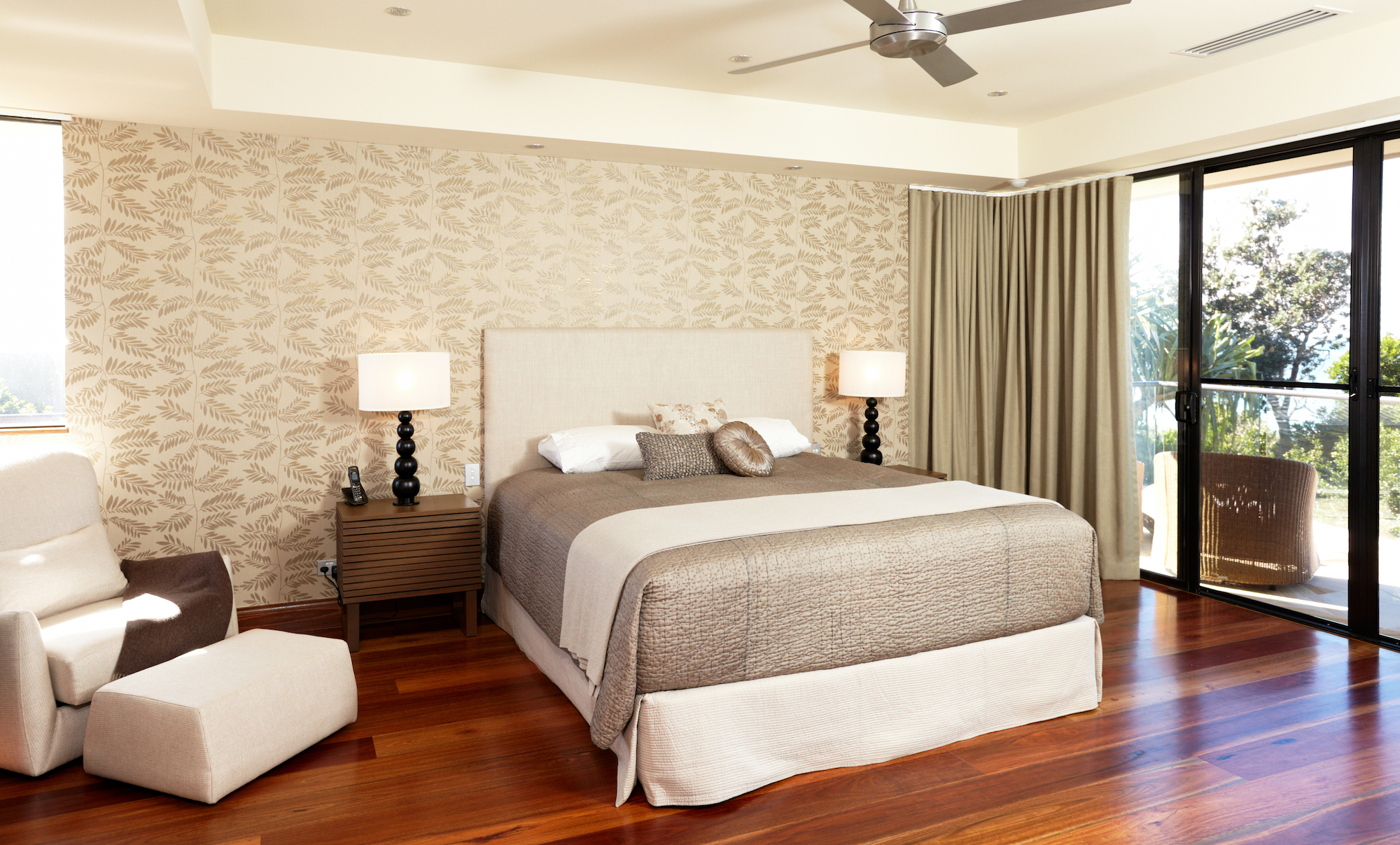 bedroom with dark wood floor and playful wallpaper