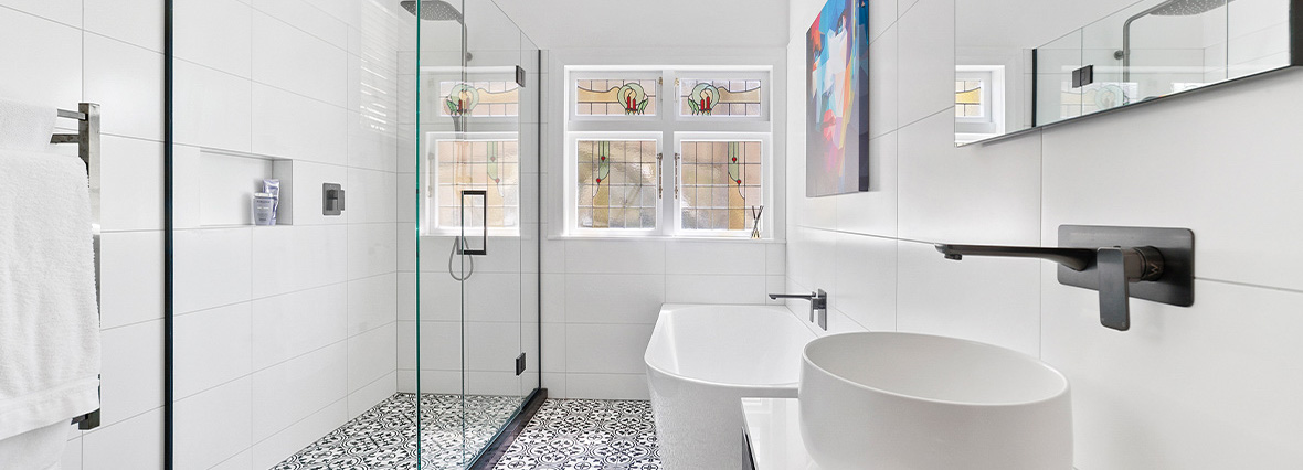 modern bathroom renovation with white and black tiles