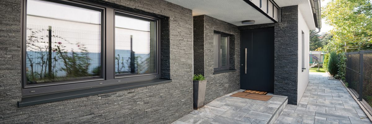 New windows and a black composite door on a house.
