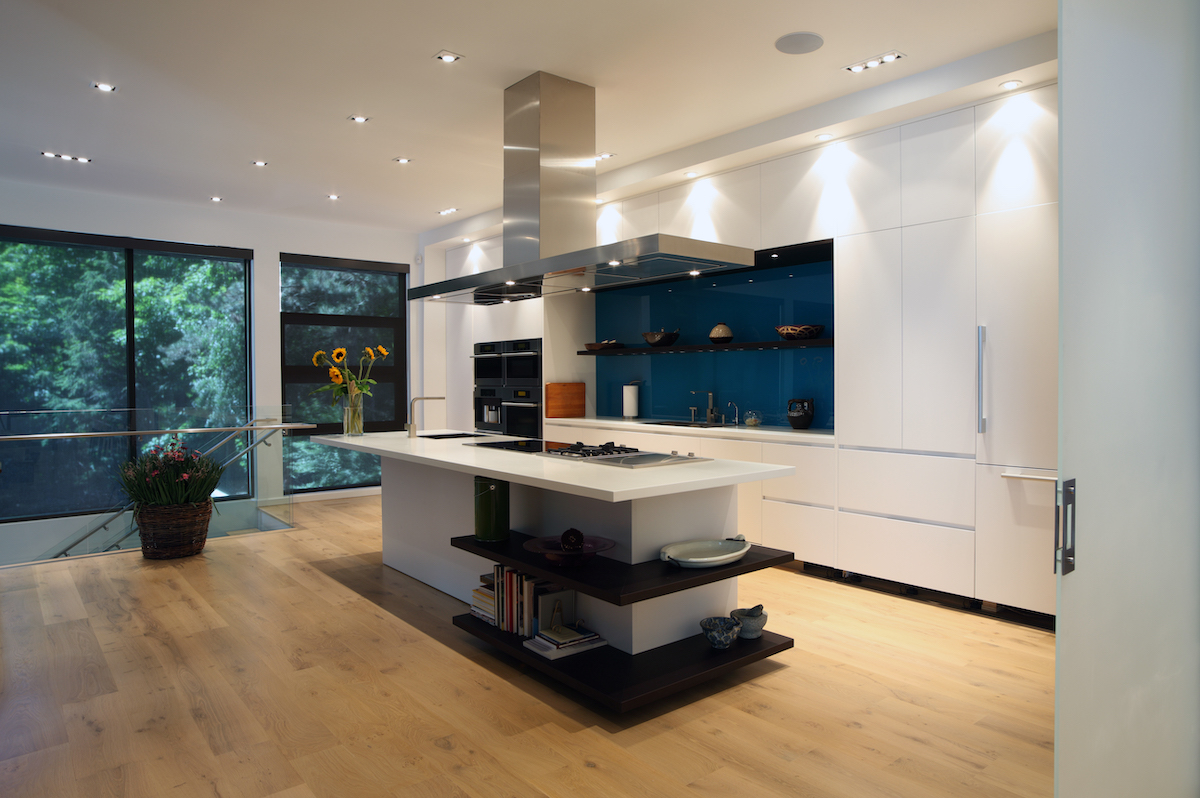 Open plan kitchen with blue splashback