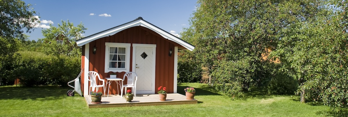 Granny flat in backyard surrounded by green grass