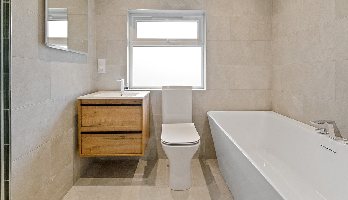 Modern Bathroom Renovation in Brighton with bathroom toilet and a wall attached bathtub 