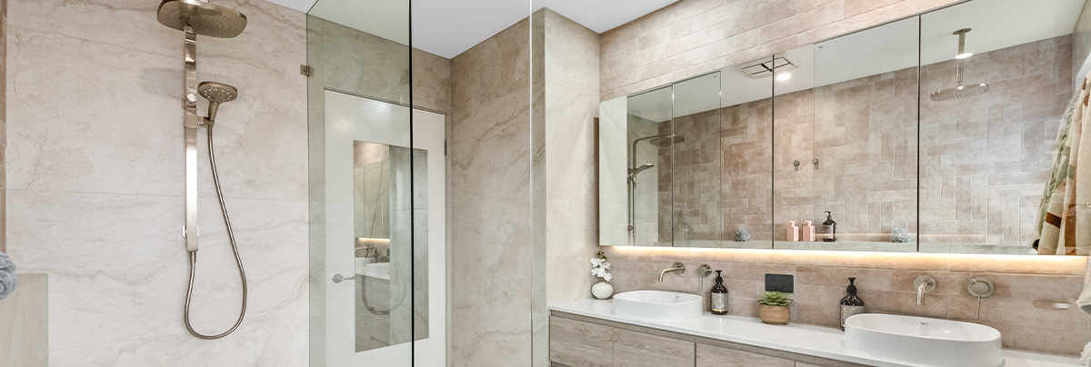 shower with glass protection and double sink under mirror with LED lights
