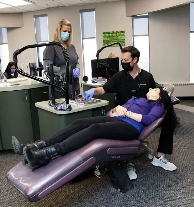 Orthodontist looking inside a patients mouth