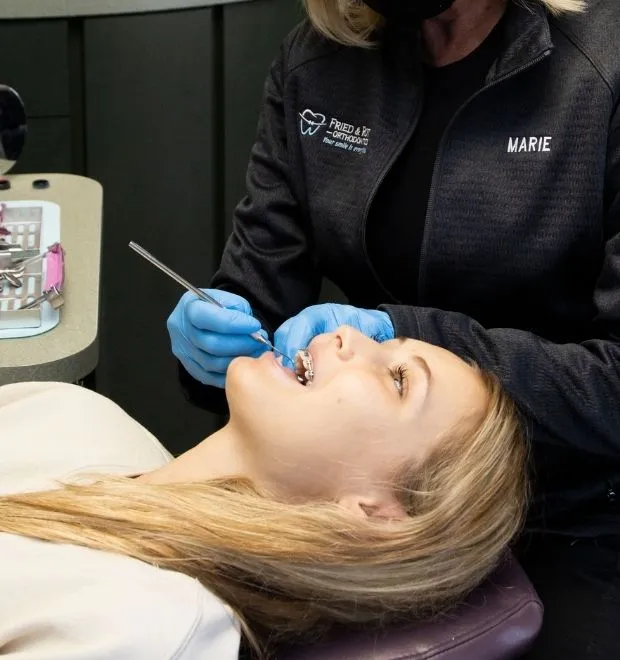 Orthodontist looking inside a patients mouth