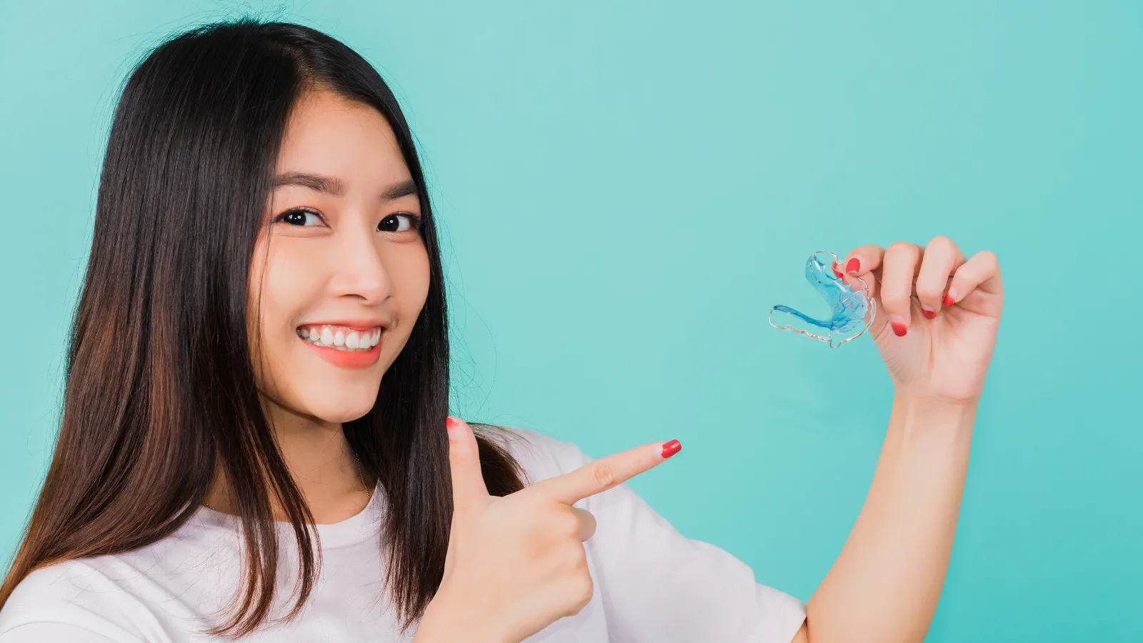 Girl pointing at a retainer