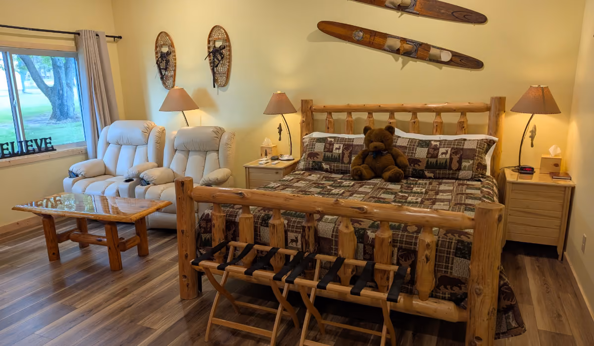 Sanctuary Suite king bed and seating area with up-north decor