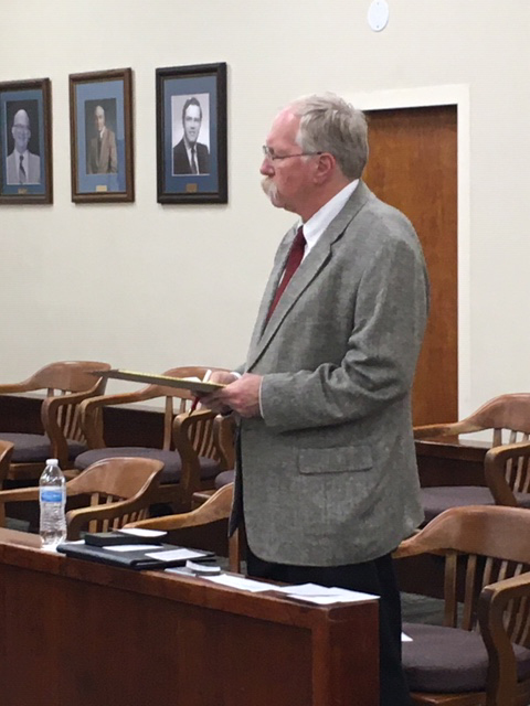 Dr. Wayne C. Matthews standing at meeting