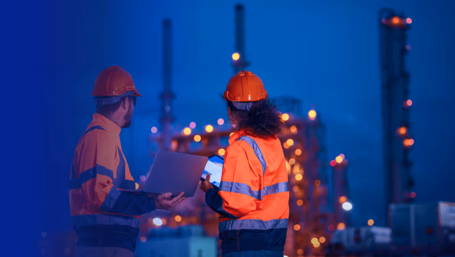 Two workers in safety gear using a laptop and tablet at a utility site, highlighting SaaS security and TPRM management.