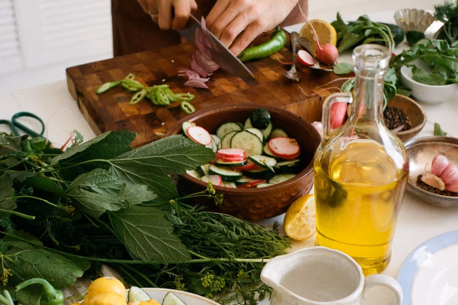 person chopping a variety of vegetables