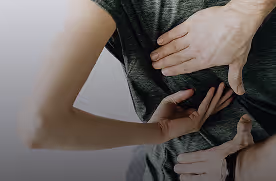 Close-up of a person receiving a chiropractic adjustment to their upper back.