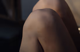 Close-up of a bent knee in soft natural light.