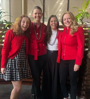 Four WellTheory teammates in red sweaters