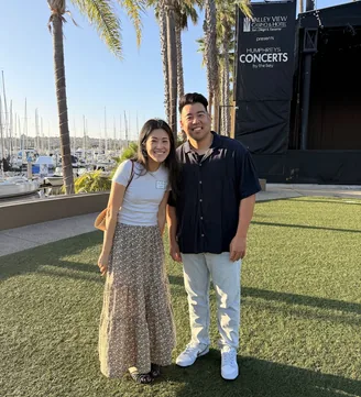 Two WellTheory teammates at an outdoor concert venue