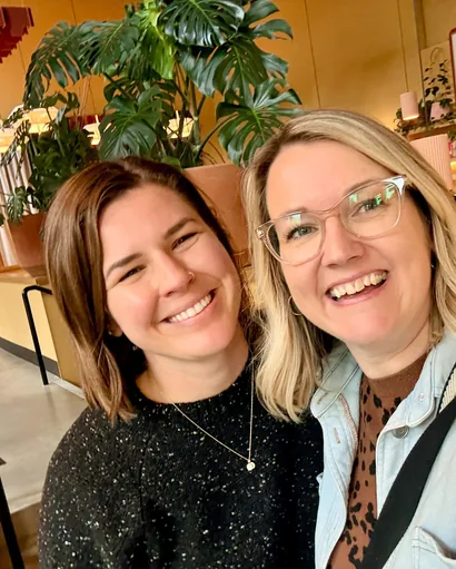 Two WellTheory teammates smiling together
