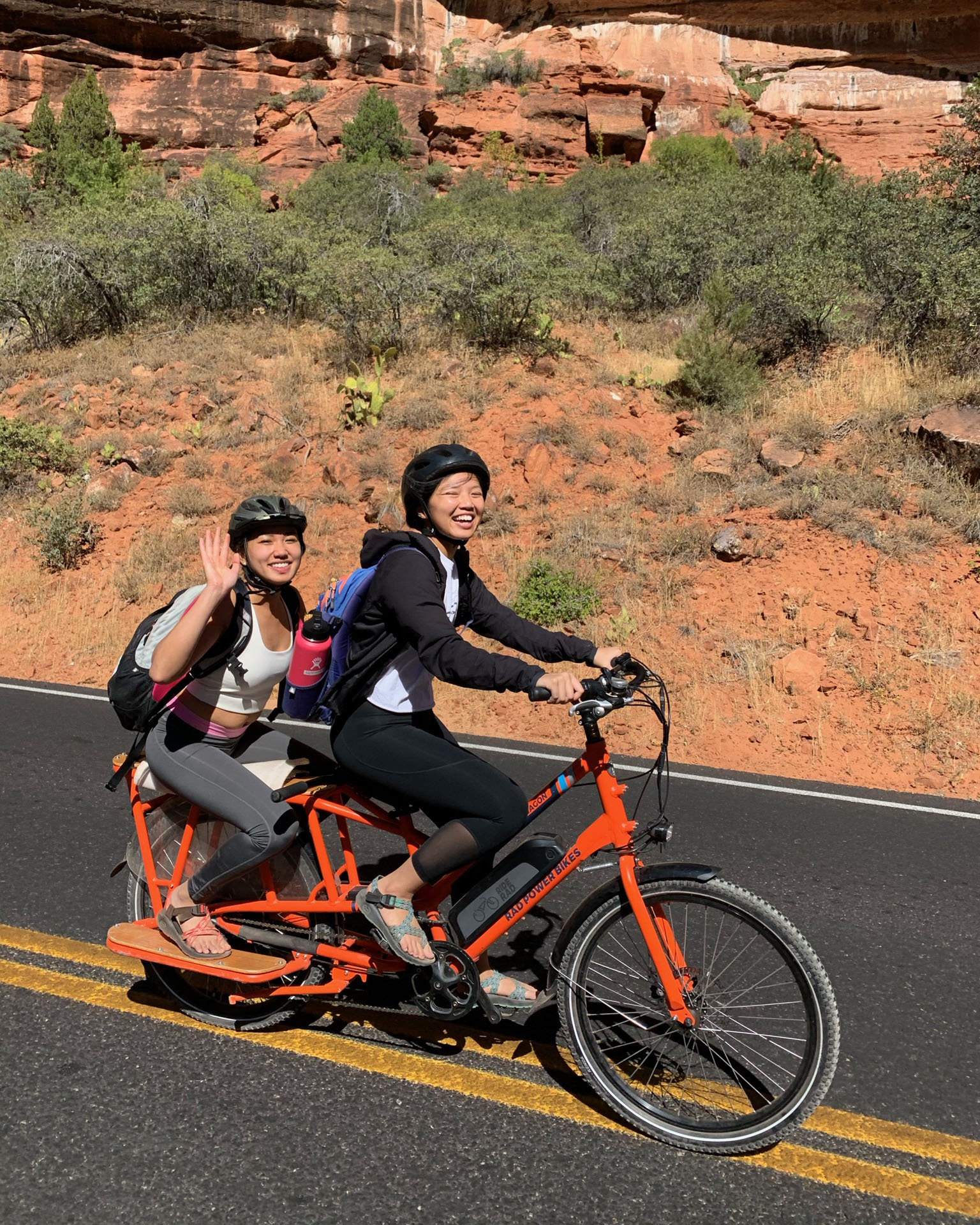 Tina riding a bike with her friend at Zion National Park.