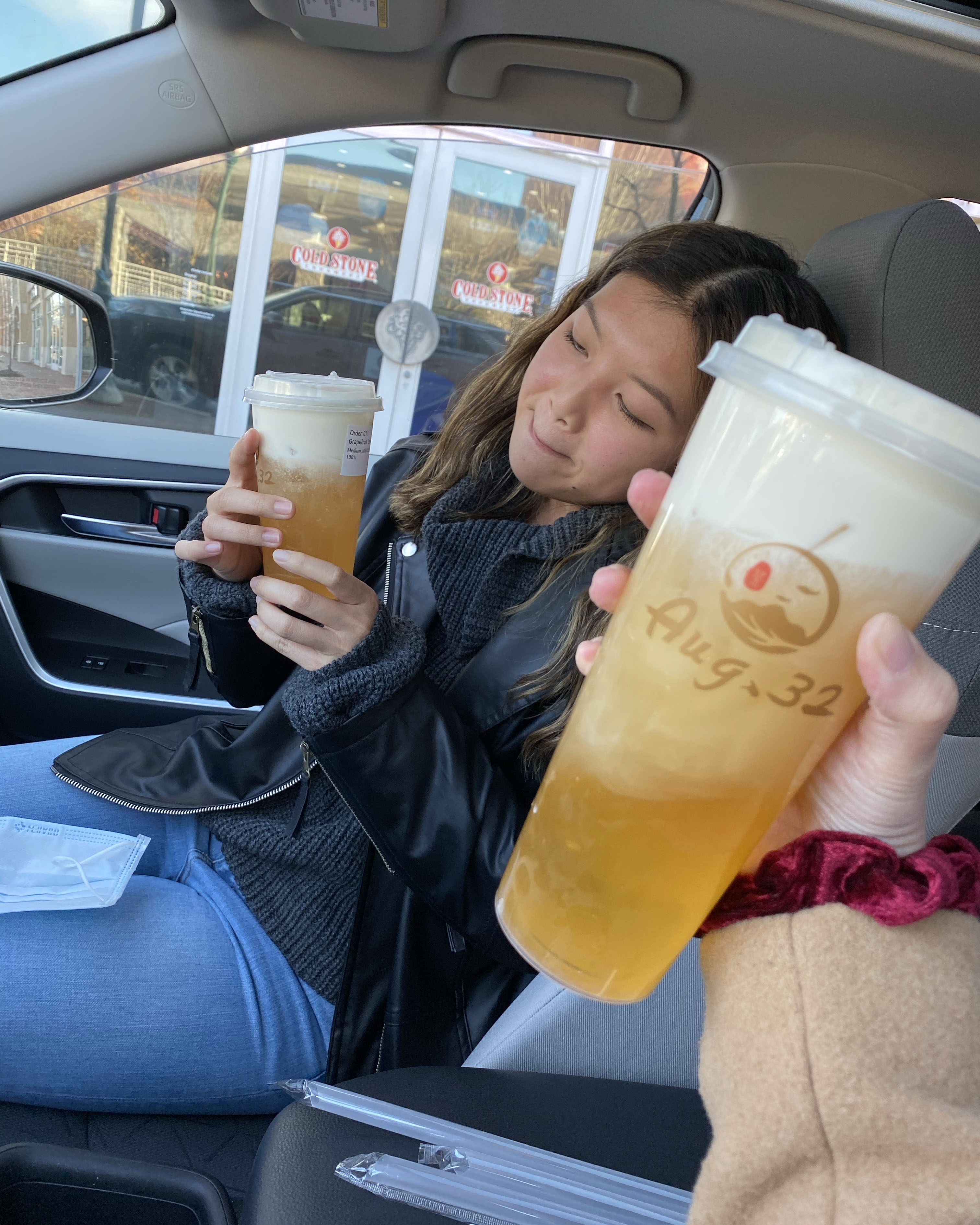 Tina making a funny face while looking at her bubble tea drink.