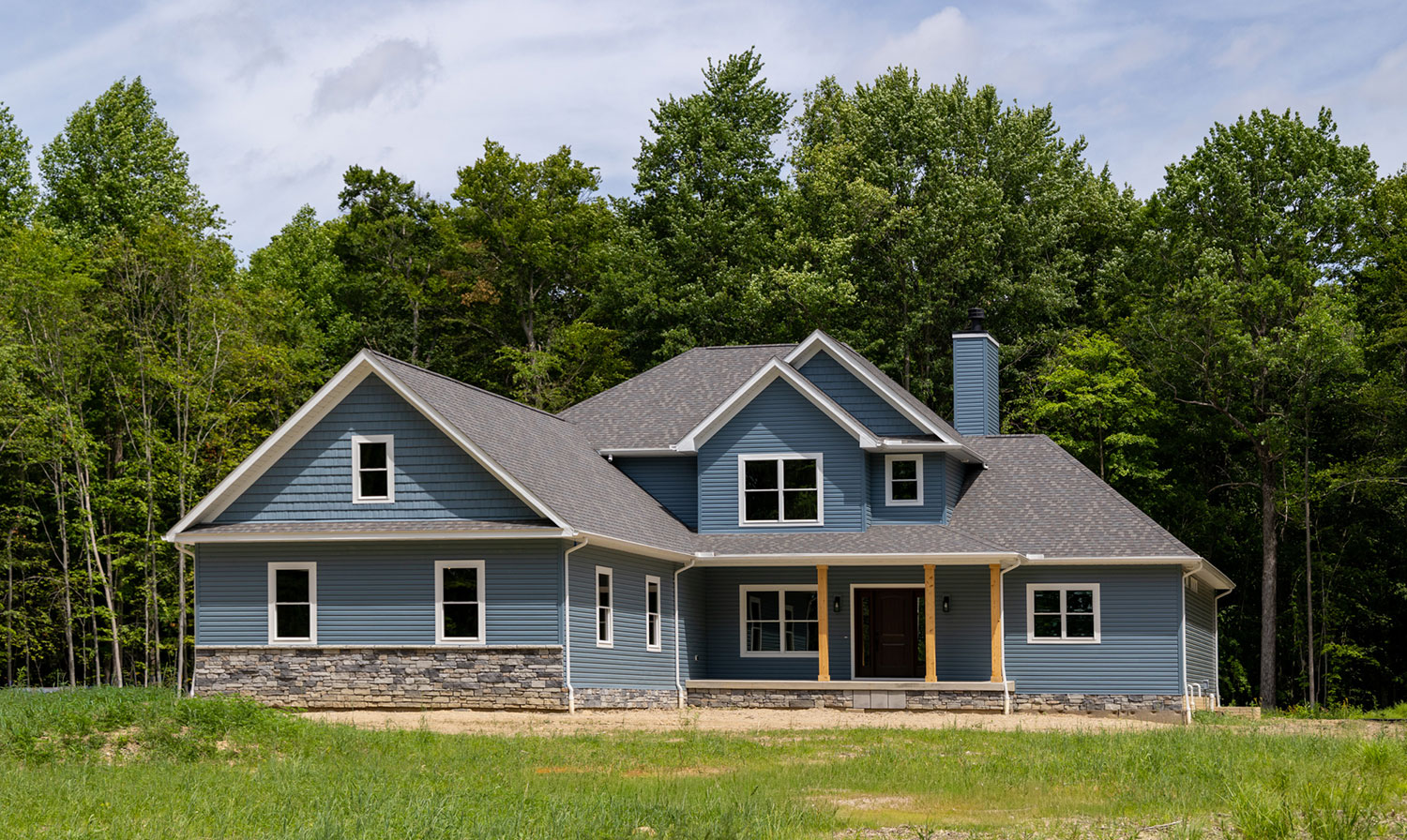 Set against a peaceful wooded backdrop, this four-bedroom, two-and-a-half-bath home blends timeless character with bright, open living. 
