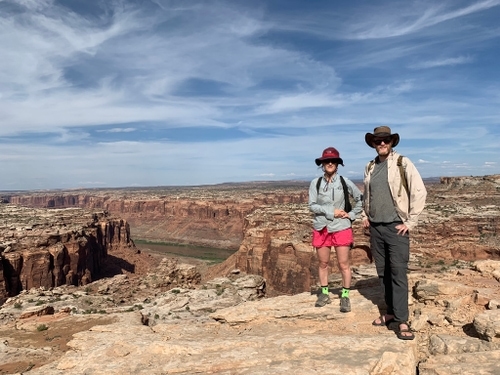 two people standing near canyon edge