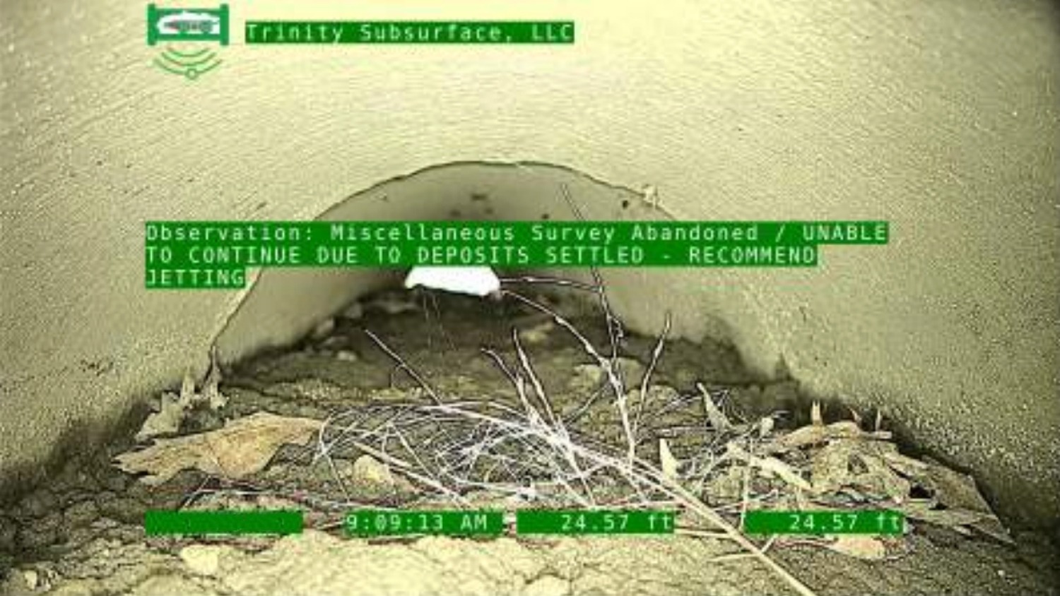 A sewer pipe blocked with settled deposits during a CCTV sewer inspection.