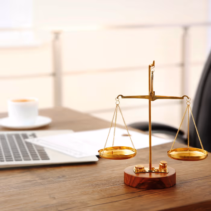 Desk with a laptop and scales of justice