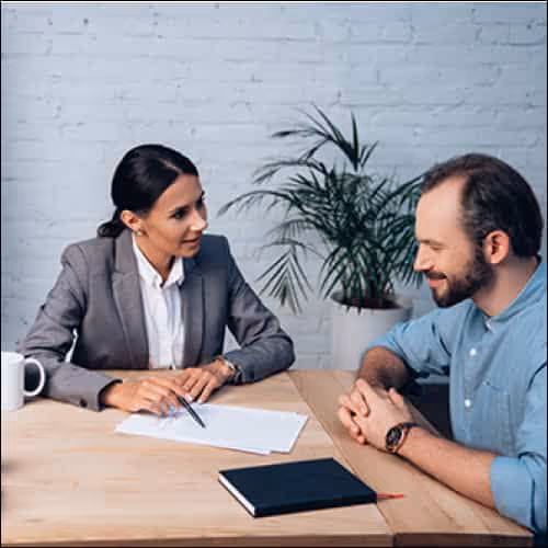 People talking through documents at a desk