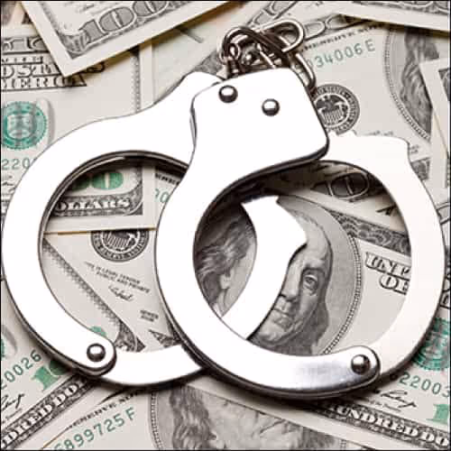 Handcuffs on dollar bills