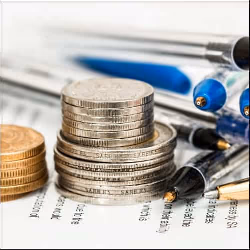 Coins with Pens on Paper