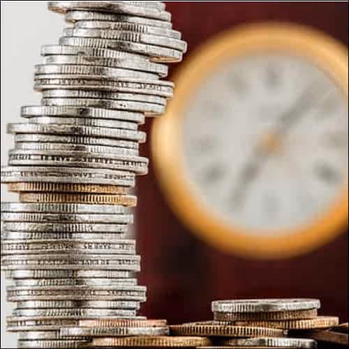 Coins with clock in background