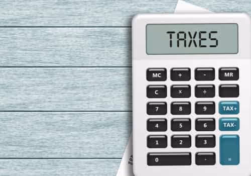Calculator with a display that says taxes