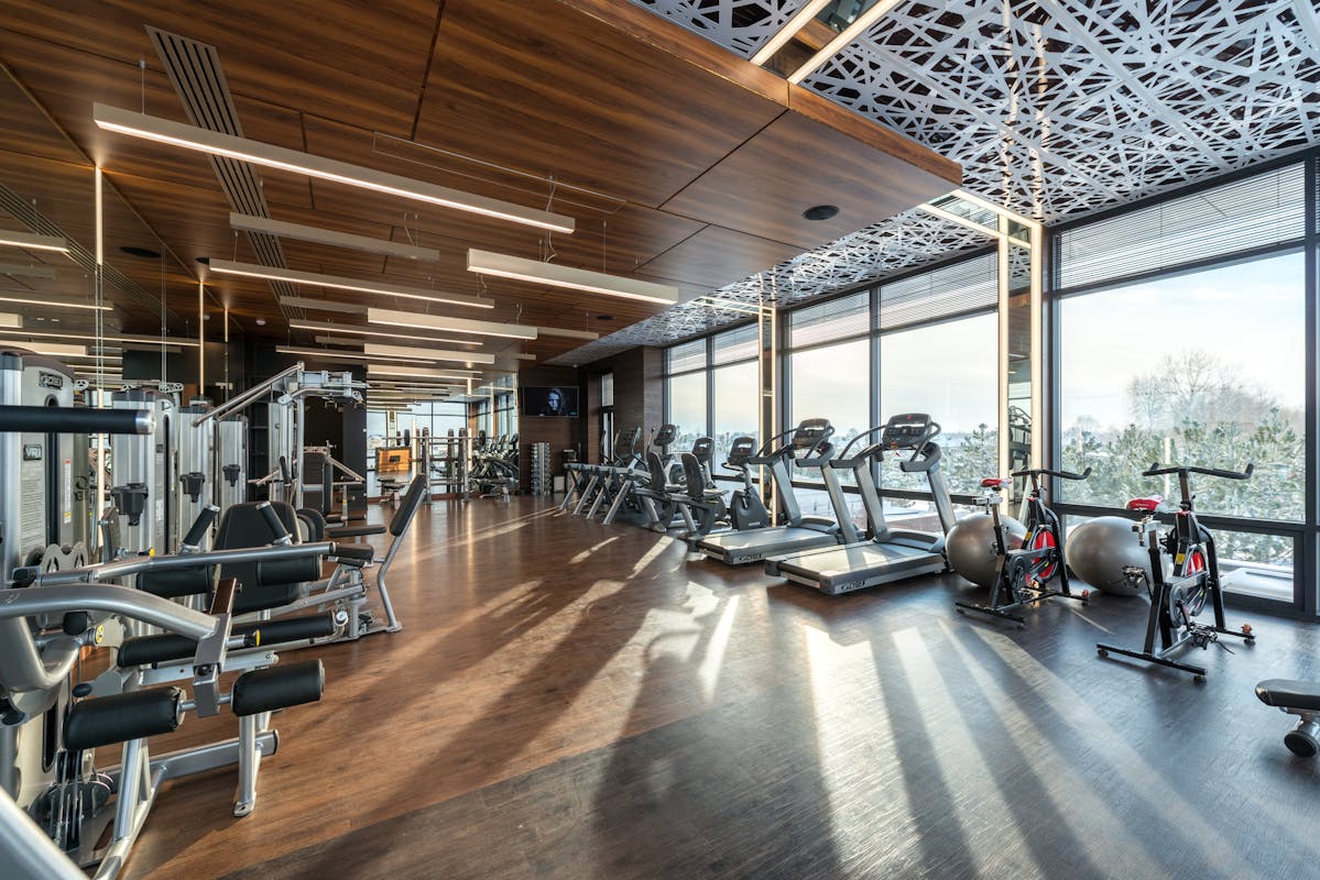 truDigital digital signage display in a modern multi-location gym lobby showing class schedules and member announcements