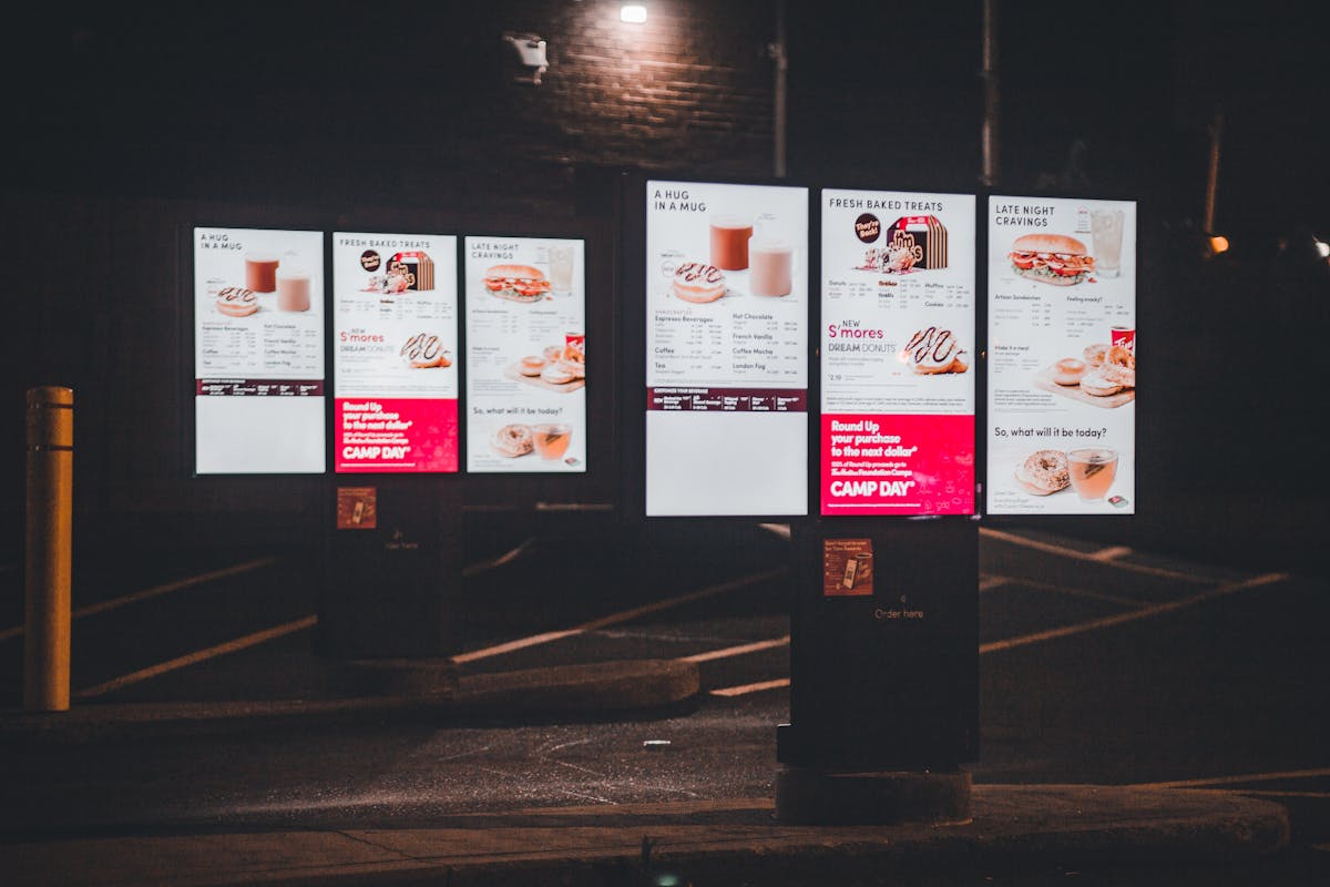 truDigital digital signage drive-thru menu boards displaying a glowing fast food menu at a restaurant at night