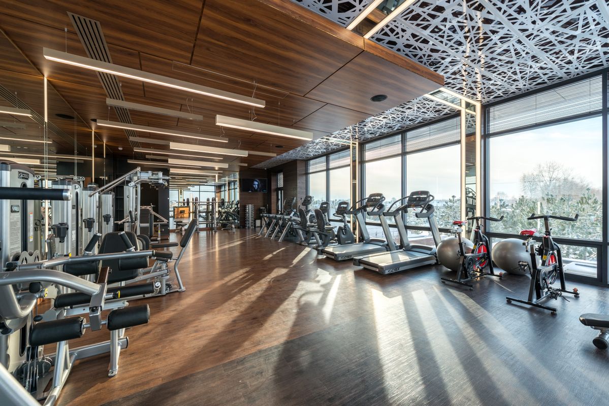 truDigital digital signage in a modern fitness club gym interior lined with cardio machines and equipment