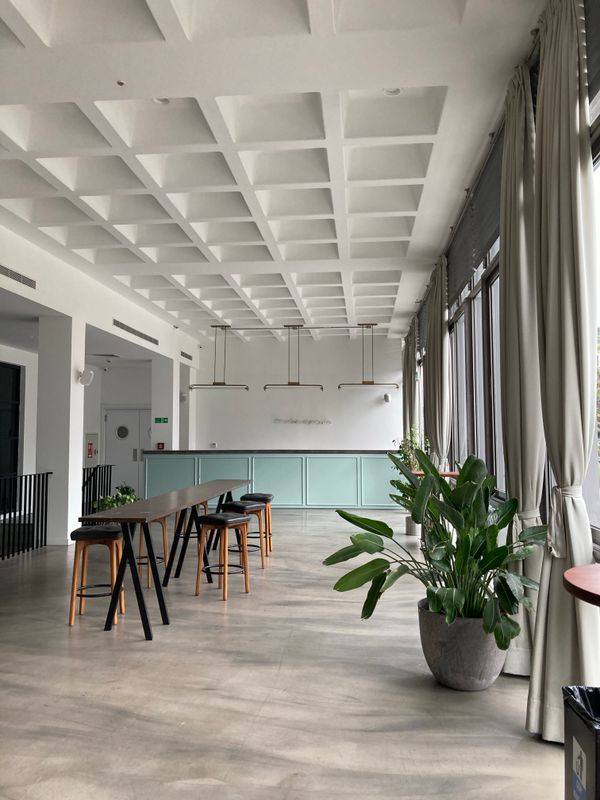 truDigital digital signage welcome screen in a modern coworking space lobby with open desks and natural light