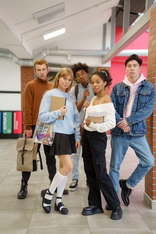 truDigital digital signage in a school hallway with a group of students gathered between classes on campus