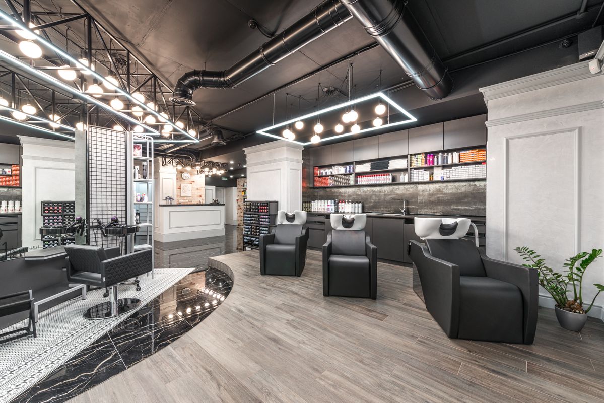 truDigital digital signage in a modern salon and spa reception area with styling stations and product retail display