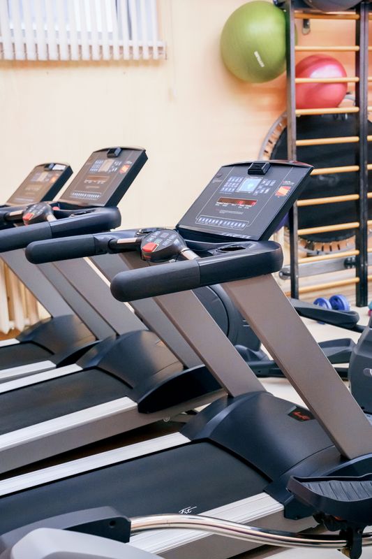 Modern gym interior with rows of treadmills, an ideal setting for truDigital digital signage for fitness centers