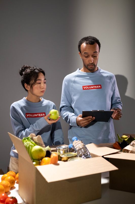 Nonprofit volunteers organizing donations, the kind of team truDigital digital signage keeps informed across every site