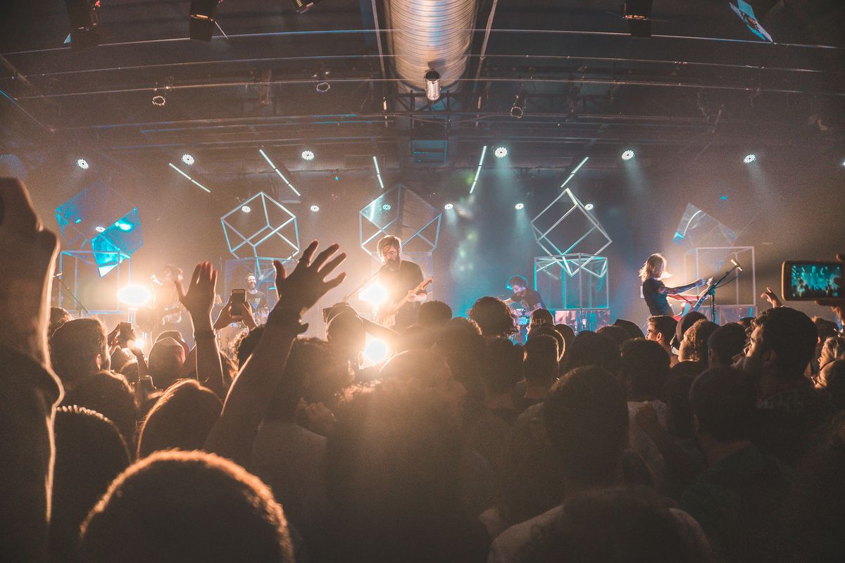 truDigital digital signage at an entertainment venue as a crowd gathers before a brightly lit concert stage