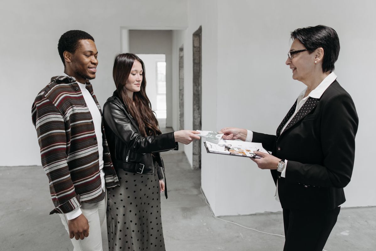 truDigital digital signage for real estate: agent reviewing house plans with a couple in an office