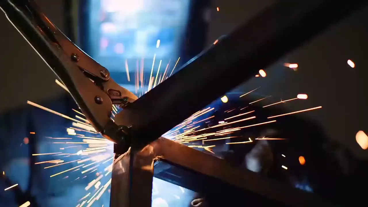 Sparks flying from a weld on a steel frame