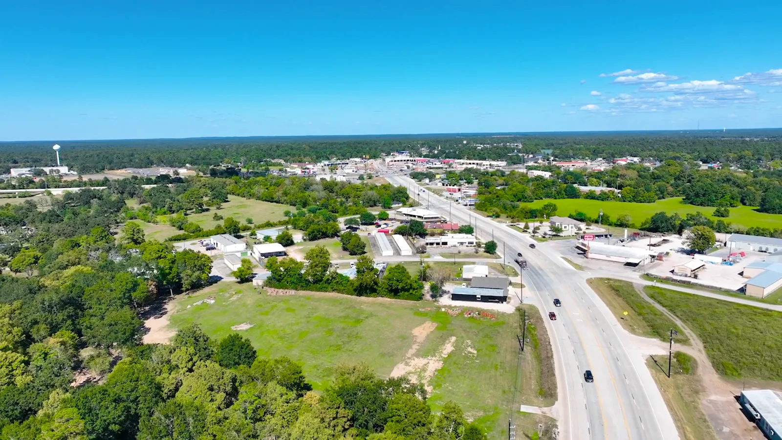 Aerial view of a Texas town and highway under a blue sky