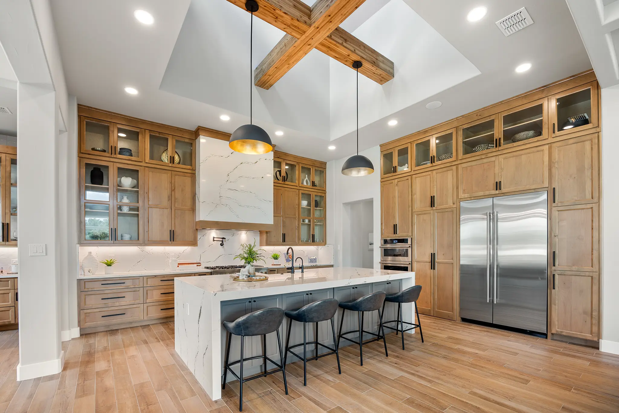 Contemporary kitchen with sleek wood cabinetry, marble backsplash, and open island layout crafted by KC Custom Homes