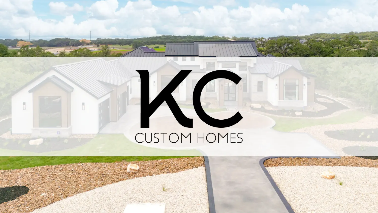 KC Custom Homes logo over a modern Hill Country style custom home with metal roof, wide driveway, and stone landscaping in New Braunfels Texas.