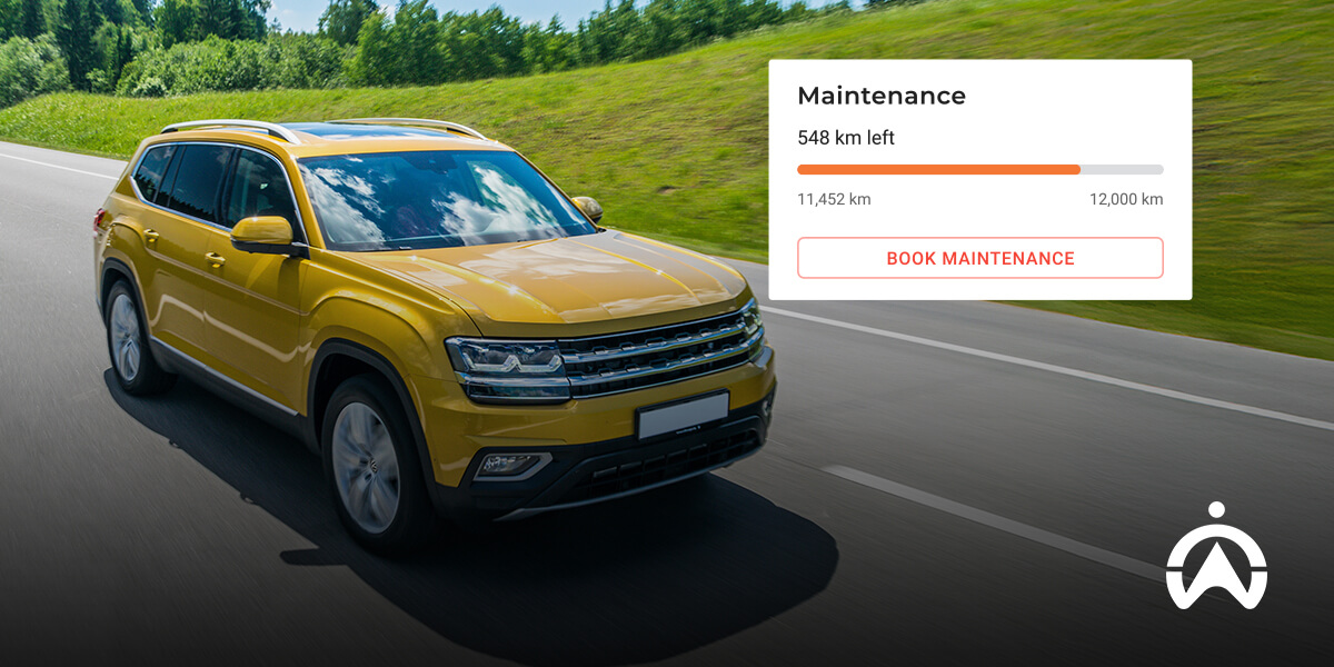 A yellow SUV drives on a road with a maintenance reminder showing 548 km left until service is due.