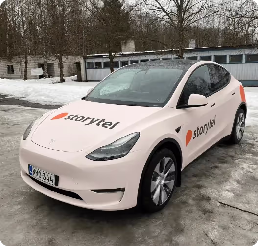 A white electric car parked in a parking lot
