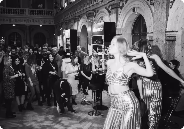 A black and white photo of a woman dancing in front of a crowd