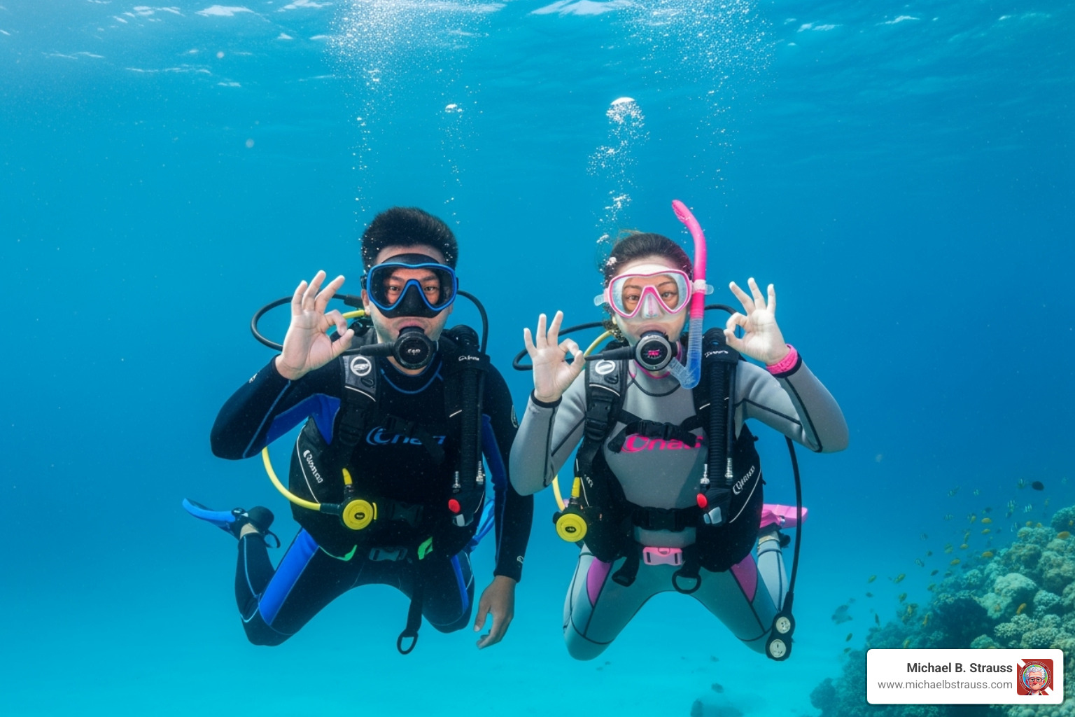 of two divers giving the 'ok' sign underwater in clear blue water - diving health and safety